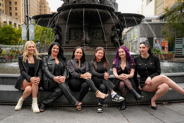 Salon Baci staff group photo sitting at Fountain Square