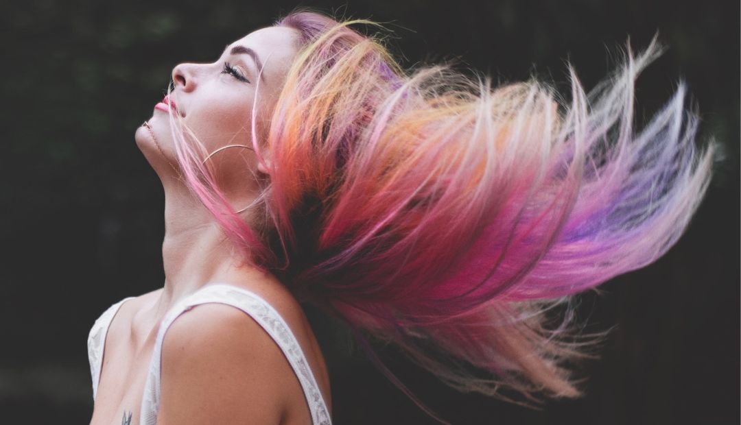 Dimensional colr V5 by Pexels from pixabay Color image of a young women posing a sideview with beautiful and multicolor long hair blowing back behind her