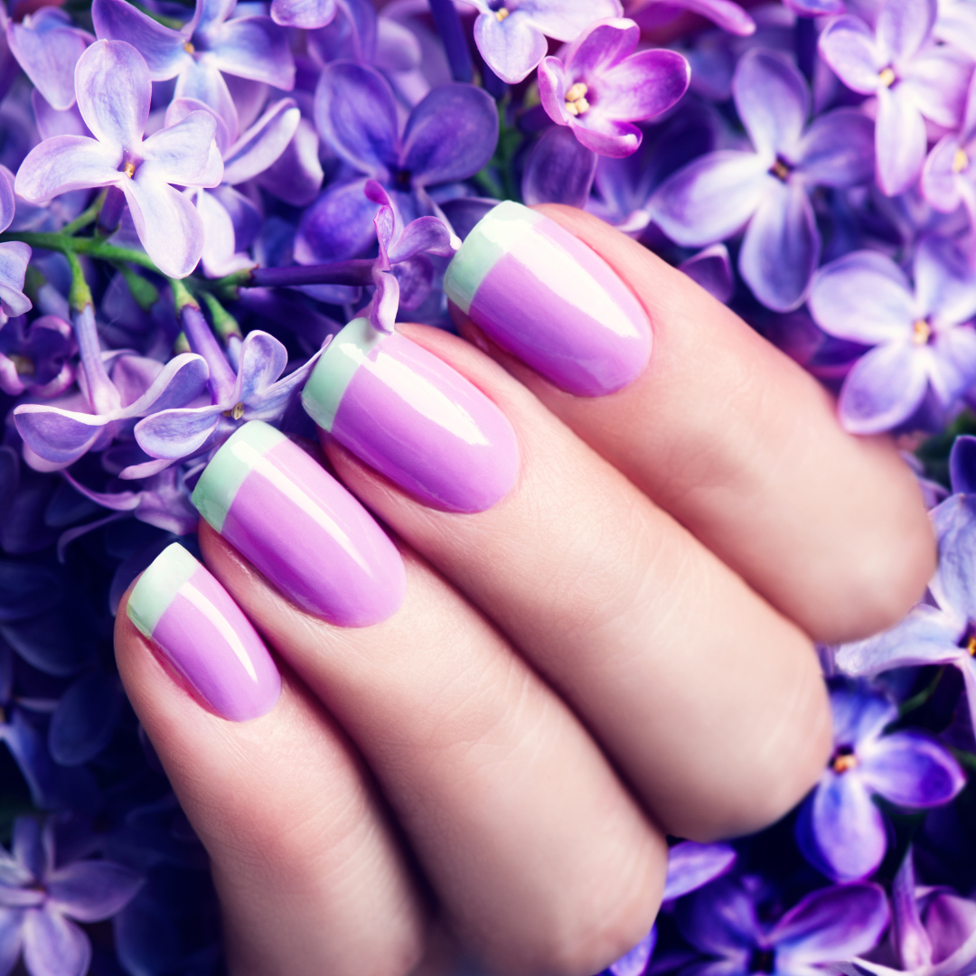 French Tips by Anna Subbotina Women's hand showing elegant French Tip Manicured with soft green tips to match her outfit.