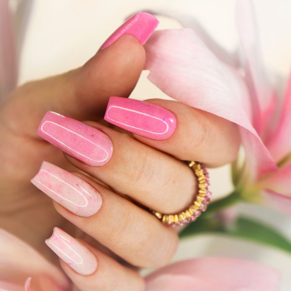 Wedding Nails by marigo20 from Getty Images Close up of nail art for a wedding showing long squared off tips in shades of pink
