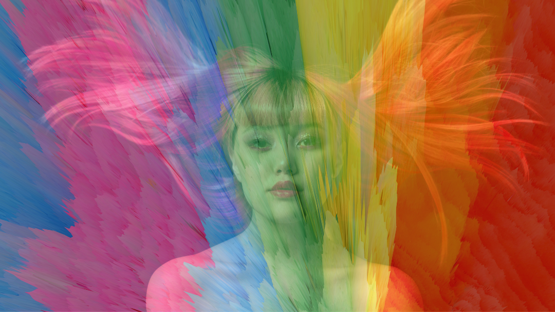 Image with bright multi color abstract background. Young women with bright red hair blowing out both sides as she looks into camera with brown eyes and red lips transparent on the background.