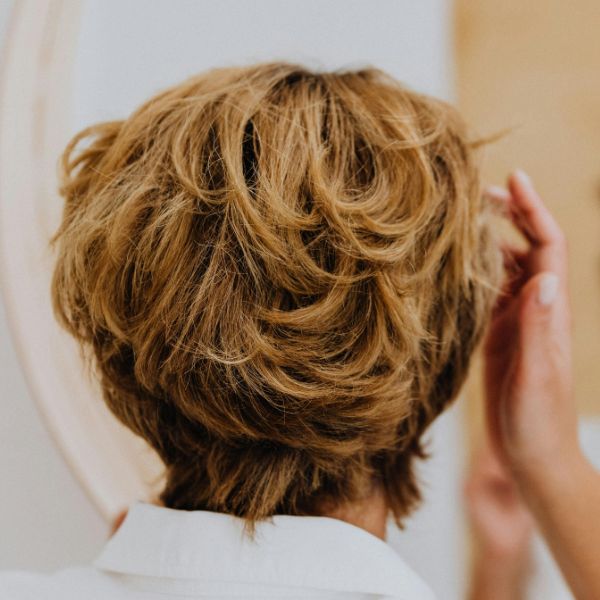Short Wavy Hair Style By Kaboompics.com from Pexels Rear view of women with short wavy hairstyle beautifully cut looking in mirror and making final touches