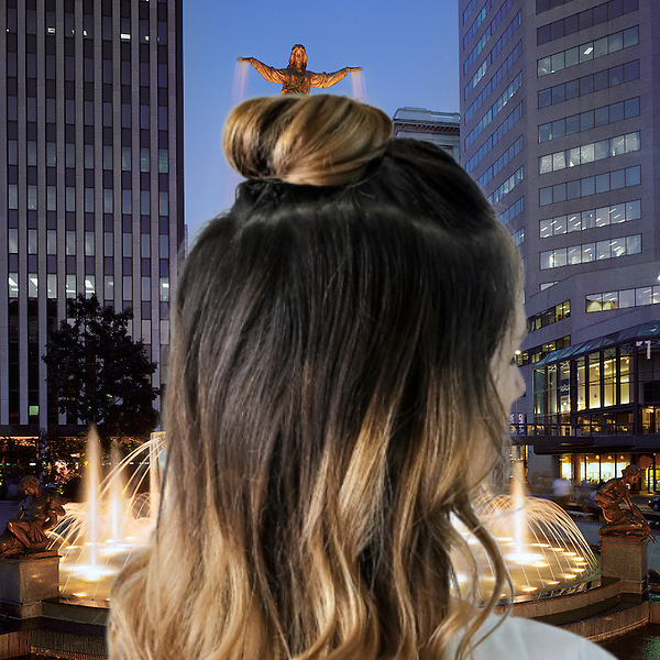 Image of a young women from a rear head view with black hair and gold lower half sections with a Half-up Top Knot