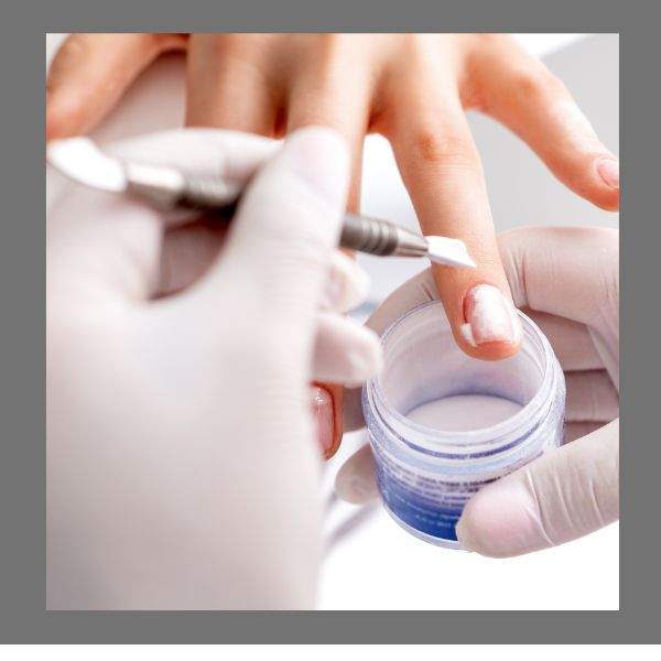 Image showing the closeup of a nail technicians hand with white rubber glove applying a professional nail treatment to a women,s nails.