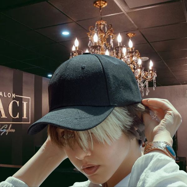 Young women in Salon Baci wearing black baseball cap with short hair