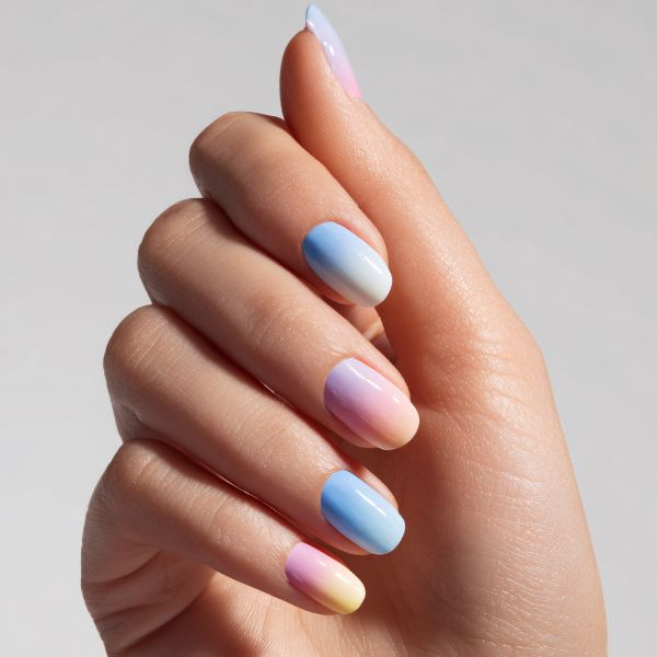 Close up view of women's right hand showing pastel wedding nail art