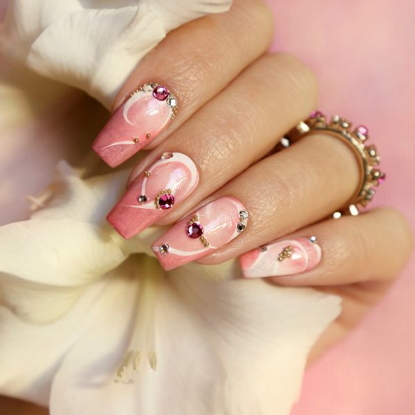 Closeup of wpmens hand with stylish #D nail design with raised elements